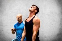Young Man Working Out with Fitness Trainer