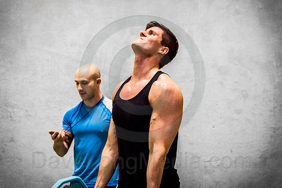 Young Man Working Out with Fitness Trainer