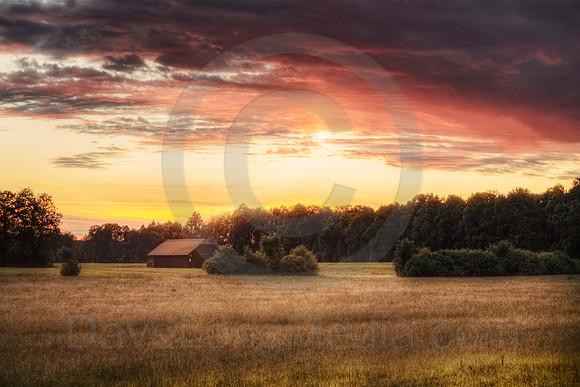 Fiery Red Sunset above Rural Landscape