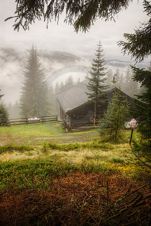 Cabin in the Alps on Misty Morning