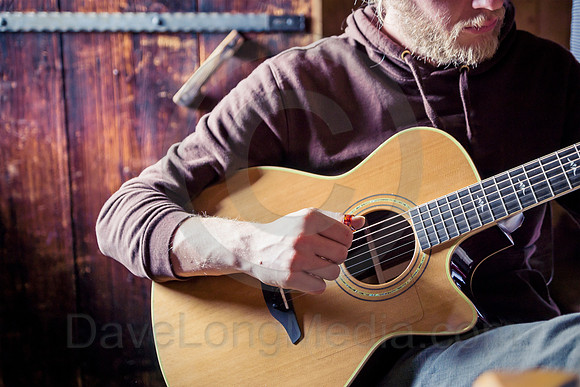 Young Man Playing Acoustic Guitar