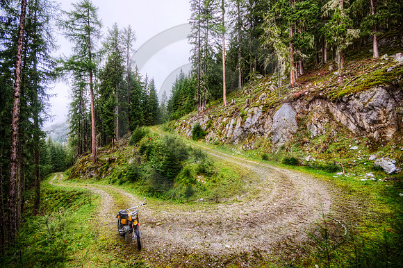 Dirt Bike and Winding Road in the Alps