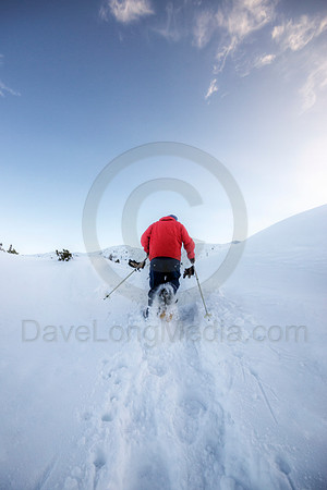 Man Running in Snowshoes High in the Alps
