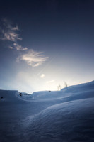 Dusk Over Snow-Covered Terrain High in the Mountains