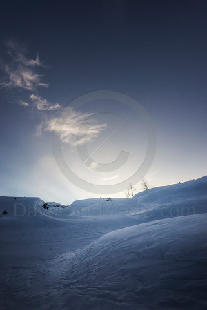 Dusk Over Snow-Covered Terrain High in the Mountains
